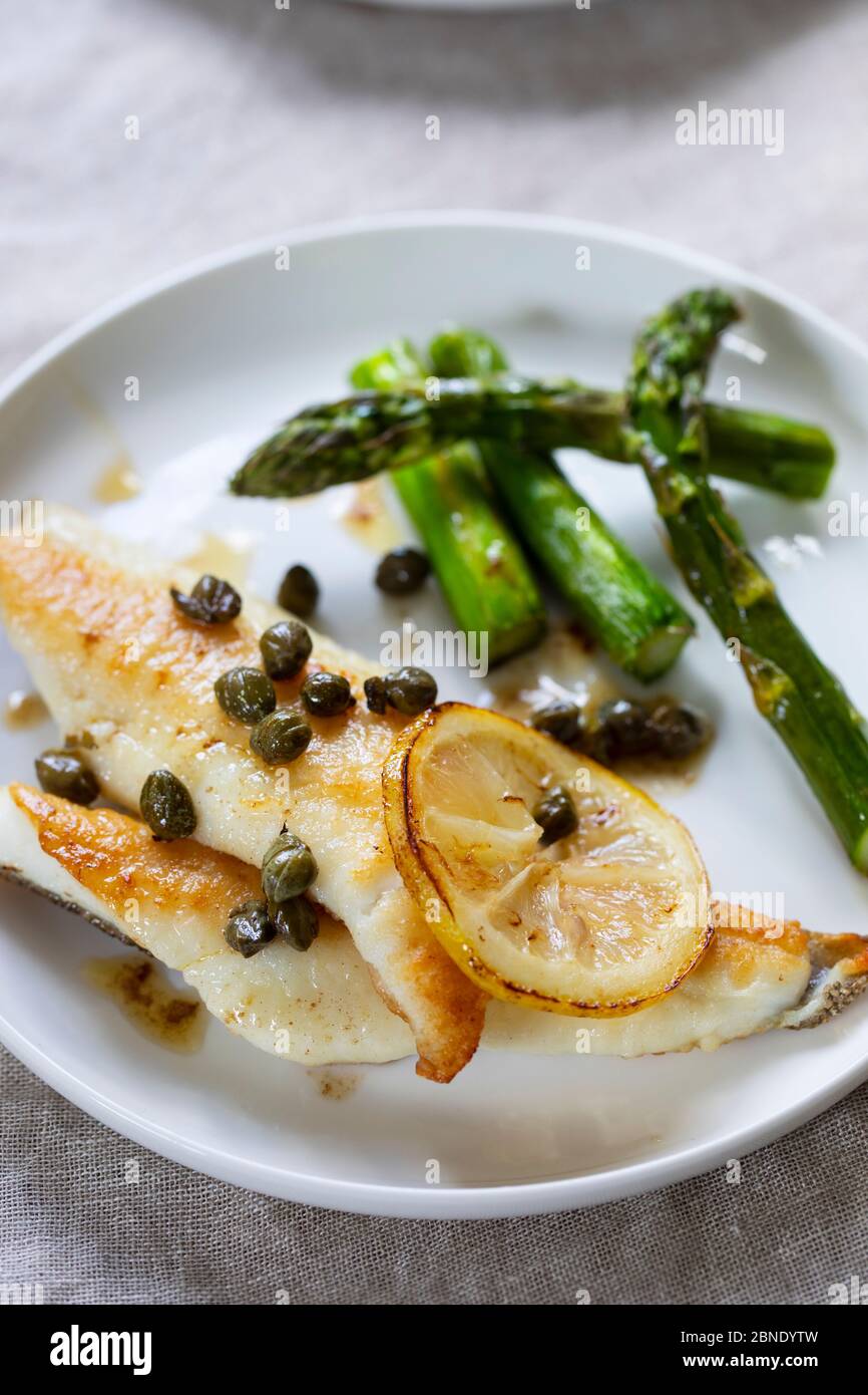 Lemon sole with butter and capers sauce and asparagus Stock Photo Alamy