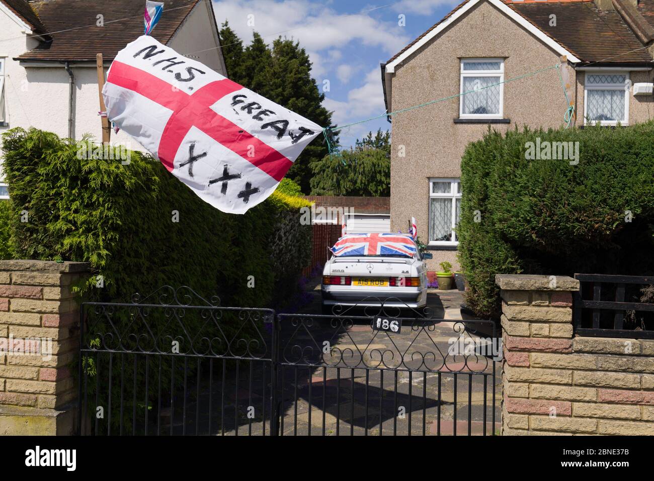 An English Flag flying outside a Suburban house in South West London with the words, NHS-Great, and three X, kisses. Stock Photo