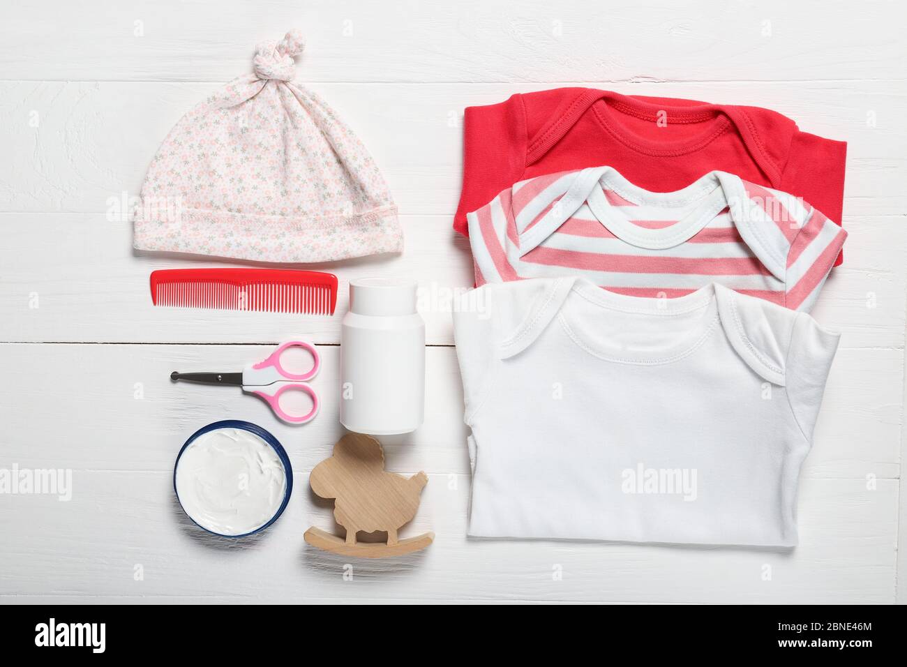 Flat lay composition with baby clothes and accessories on wooden background Stock Photo