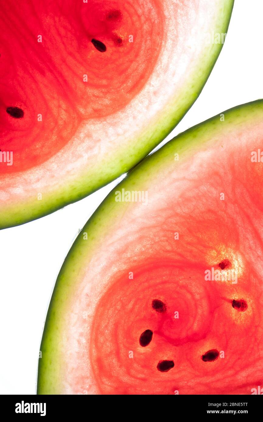Water melon (Citrullus lanatus var. lanatus) cross section backlit. Stock Photo