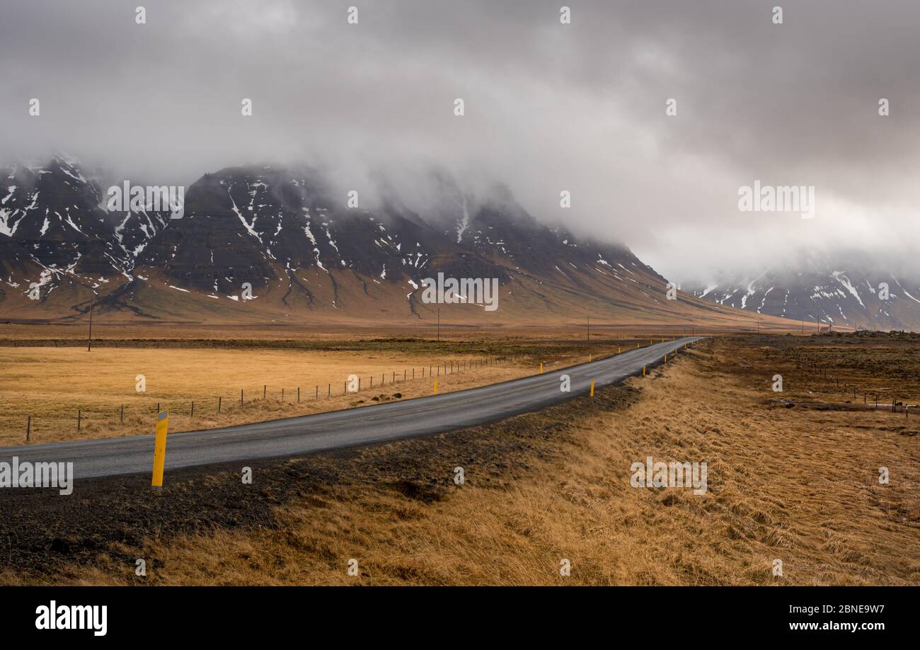 Highway countryside straight empty road leading to the snowy mountains at snaefellsnes peninsula in Iceland Stock Photo