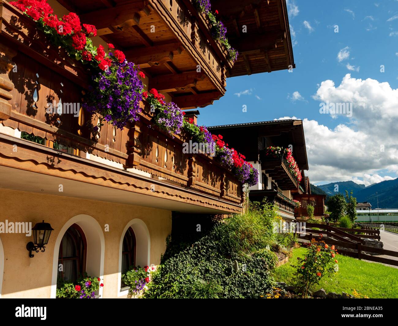Balconies and terraces decorated with colorful potted flowers in an alpine resort in Austria. Grossarl. Stock Photo