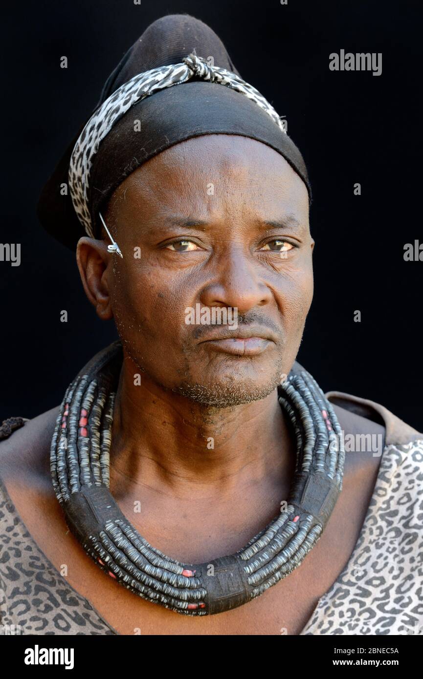 Himba man with a modern dress but wearing a typical necklace and a turban he never removes. Kaokoland, Namibia October 2015 Stock Photo