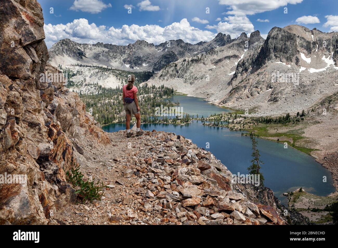 Day hiker on trail above Twin Lakes, Sawtooth Wilderness, Sawtooth National Recreation Area, Idaho, USA. July 2015. Model released. Stock Photo