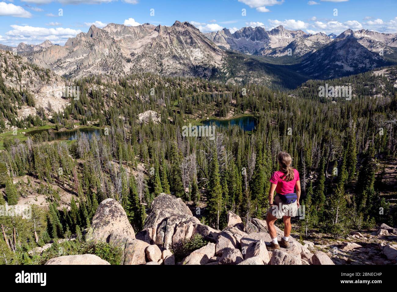 Hiker below Baron Pass overlooking  Redfish Lake Creek Valley, Idaho, USA. July 2015. Model released. Stock Photo