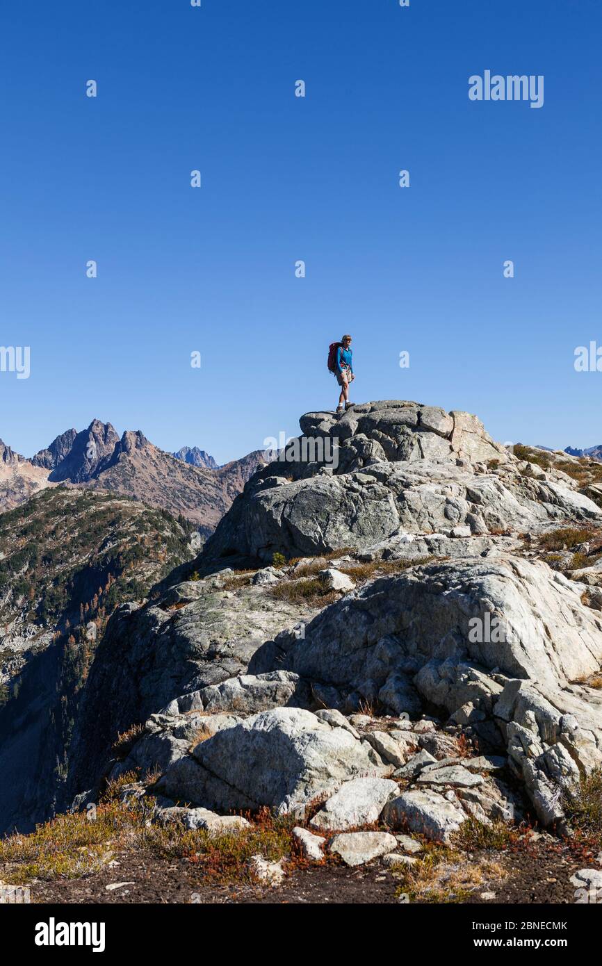Hiker above Horsefly Pass, North Cascades National Park Complex, Washington, USA. October 2015. Model Released. Stock Photo