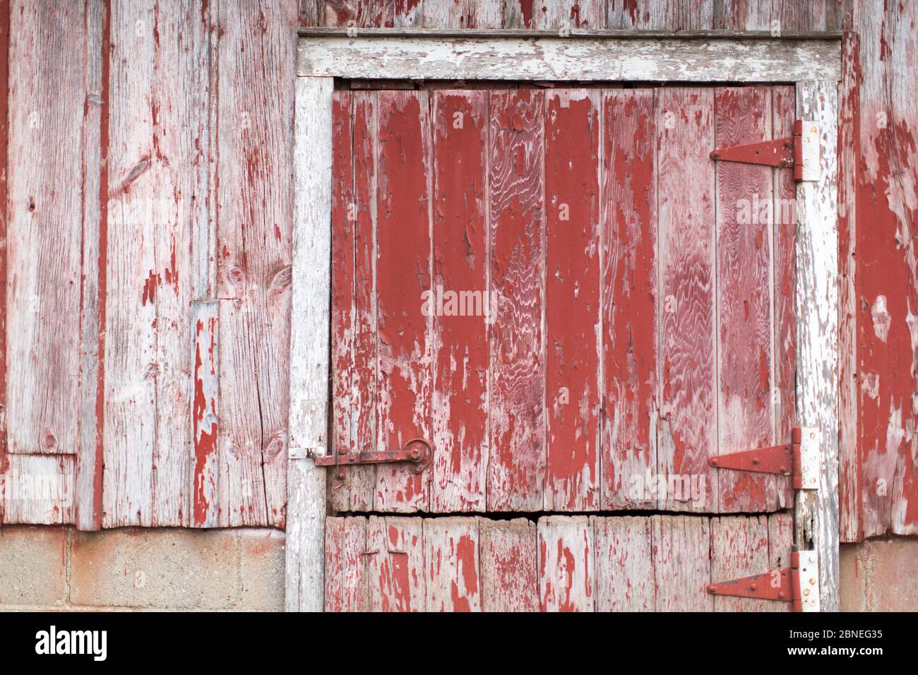 Barn door close up, weathered wood with red paint Stock Photo