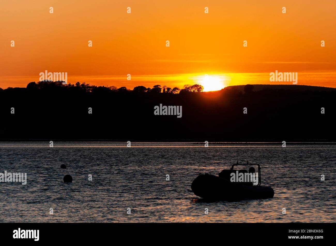 Courtmacsherry, West Cork, Ireland. 14th May, 2020. The sun sets spectacularly over Courtmacsherry Marina after a day of sunshine. Credit: AG News/Alamy Live News Stock Photo
