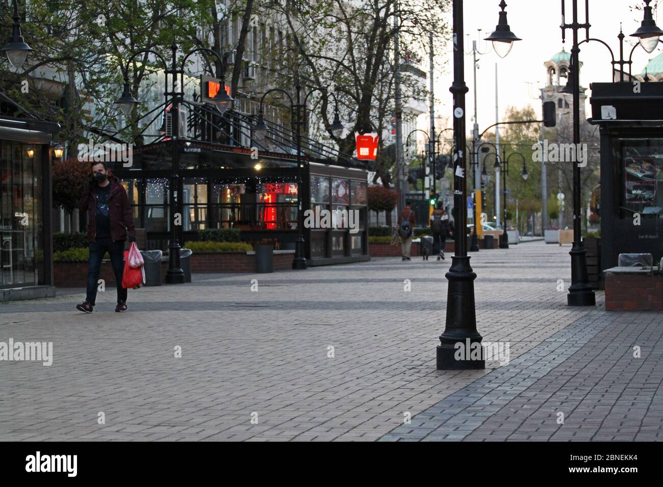 Sofia, Bulgaria – April 17, 2020: COVID-19 Pandemic Coronavirus. Man on city street wearing face mask protective for spreading of disease virus SARS-C Stock Photo