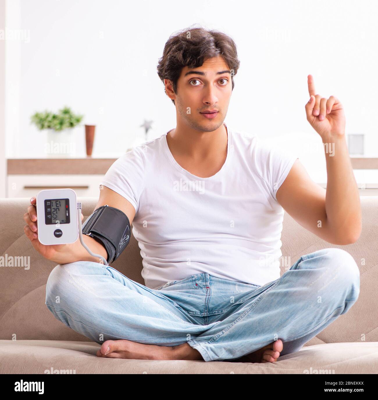 The young man measuring blood pressure at home Stock Photo - Alamy