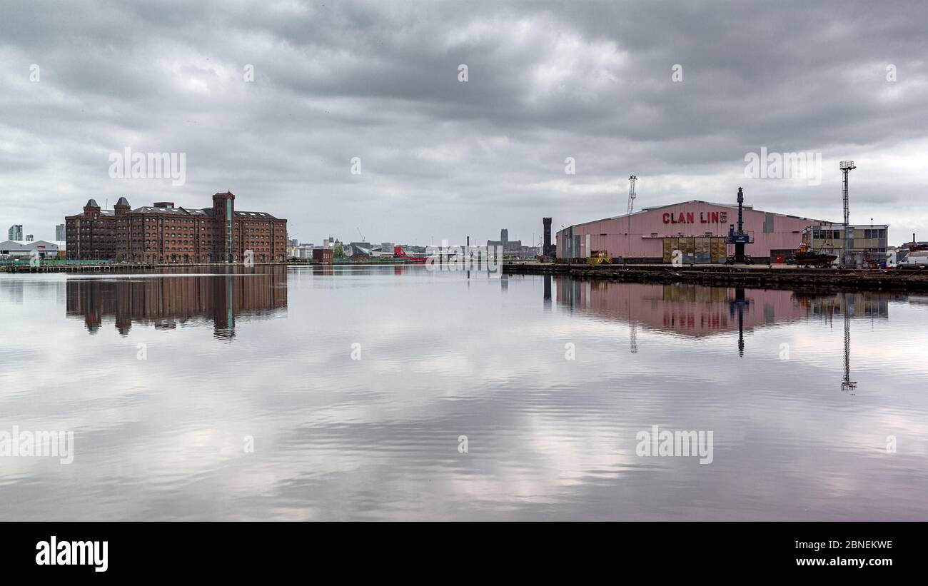 East Float dock basin, Birkenhead. Reflected East Float Quay and Clan Line shed buildings and sky. Stock Photo