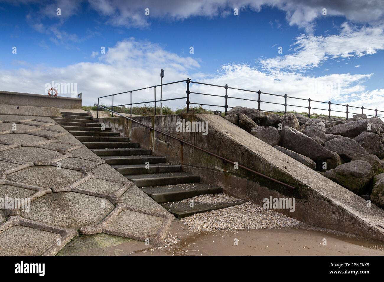 Wallasey embankment coastal defence system, concrete steps from beach onto raised promenade, Leasowe Bay, Wirral. Stock Photo