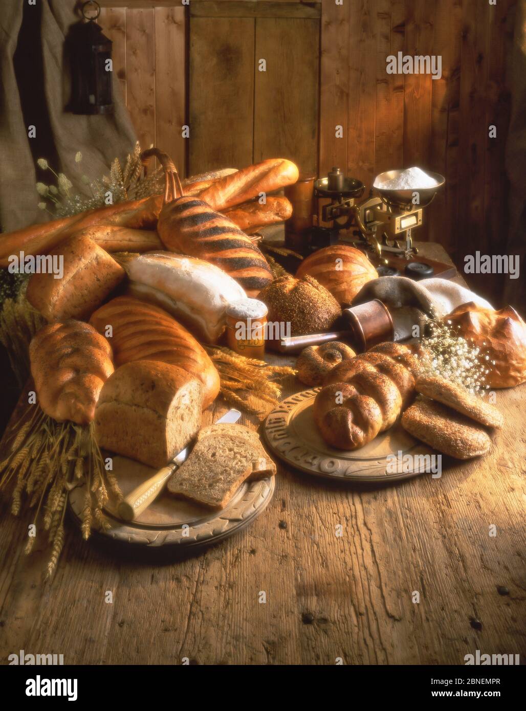 Selection of breads, breadboard and flour, Winkfield, Berkshire, England, United Kingdom Stock Photo