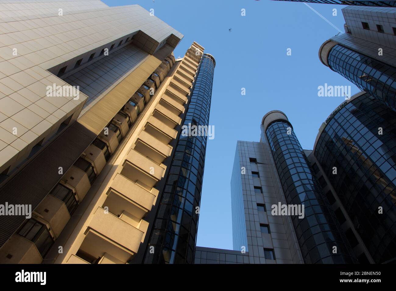Low angle shot of high-rise buildings under a clear blue sky Stock ...