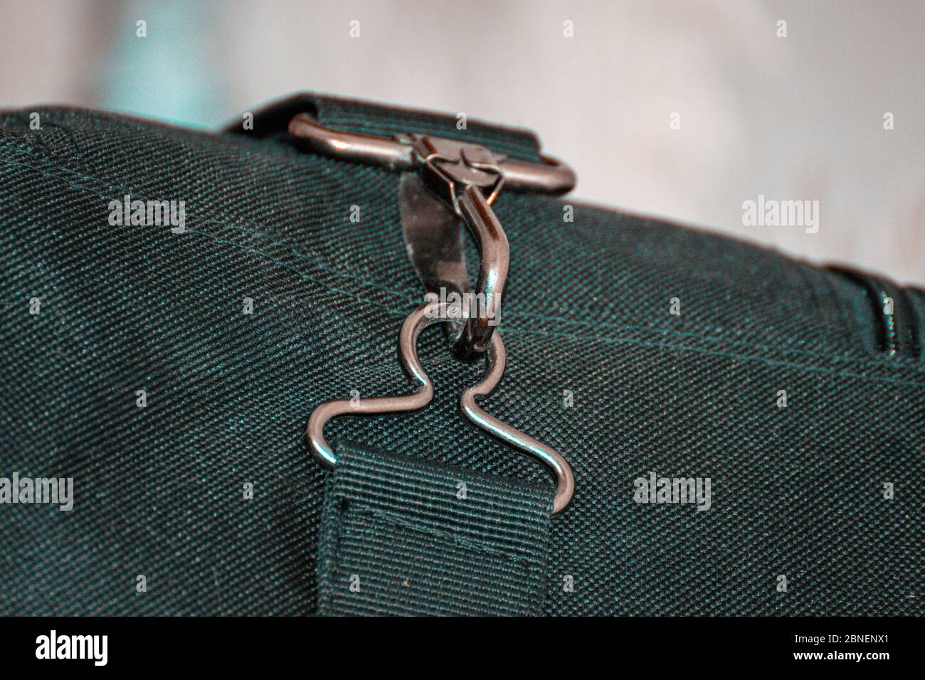 Bag black belt rope strap lanyard, hanging metal clasp snap latch hook carabiner closeup. Stock Photo