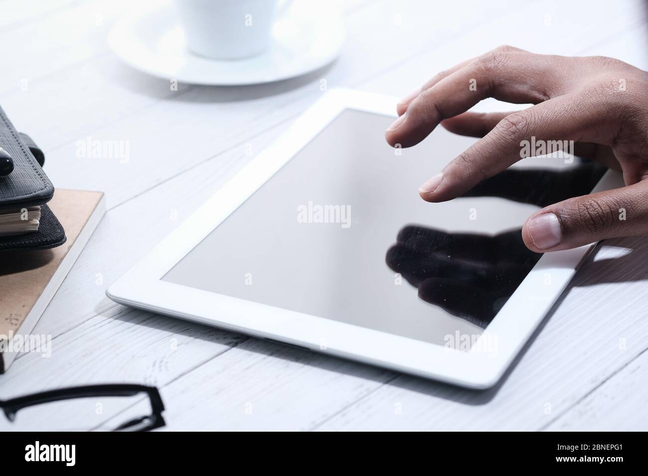 close up of man's hand using digital tablet with empty screen  Stock Photo