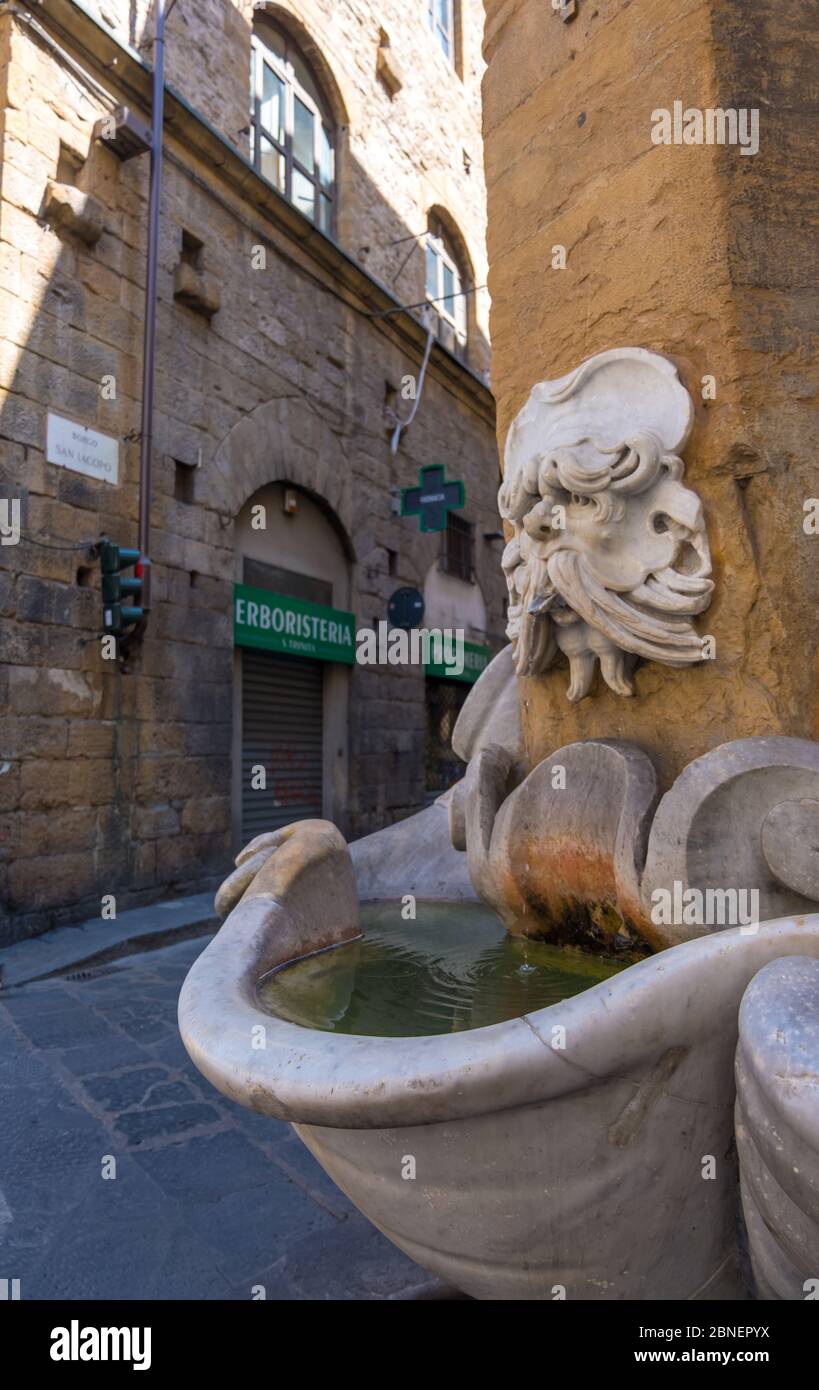 Florence, Italy August 16, 2019 Fountain on medieval street in
