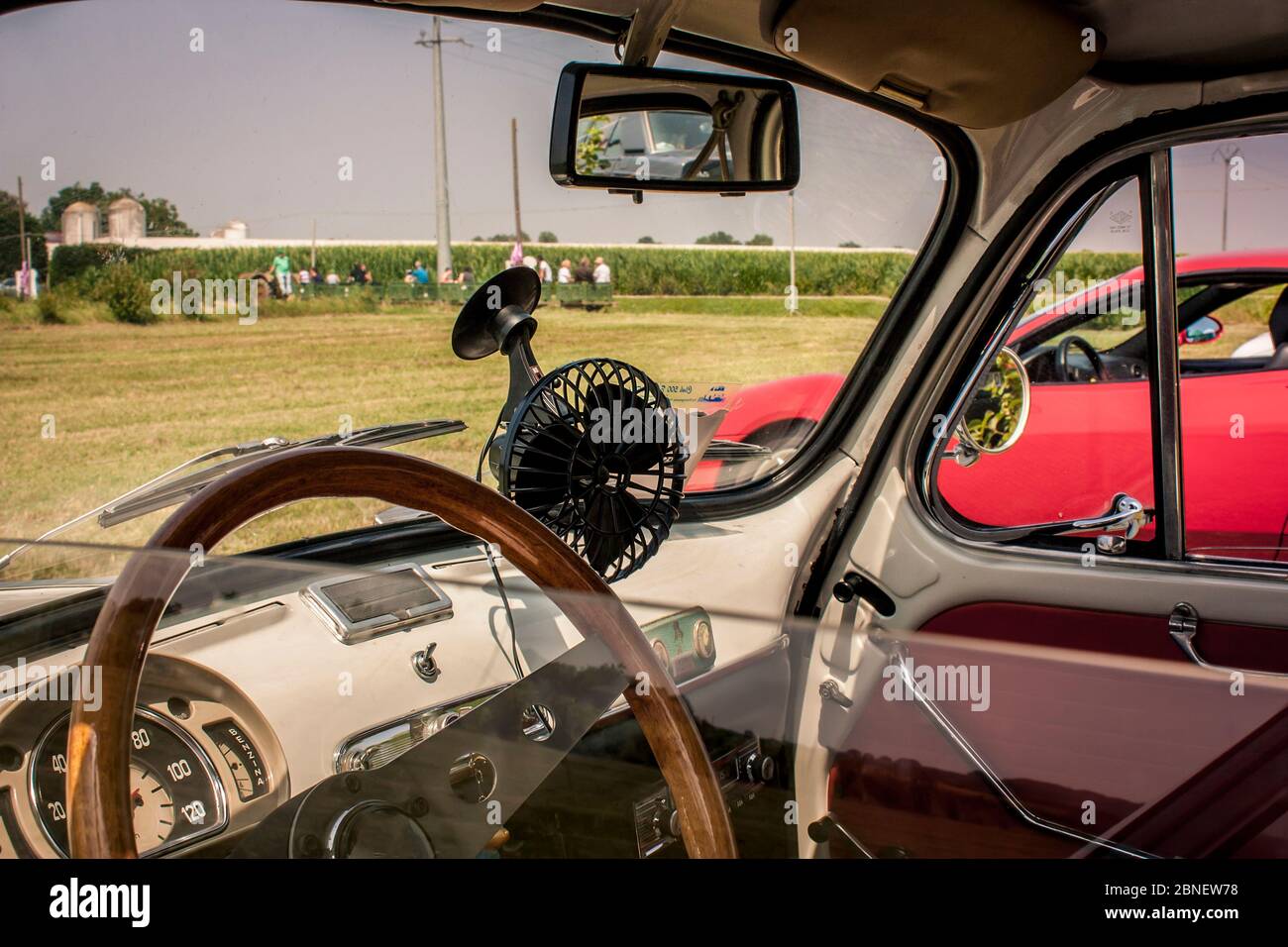 Interior of a Fiat 500 fully restored in view of a typical Italian countryside. Not just a car but an icon that created automotive history Stock Photo