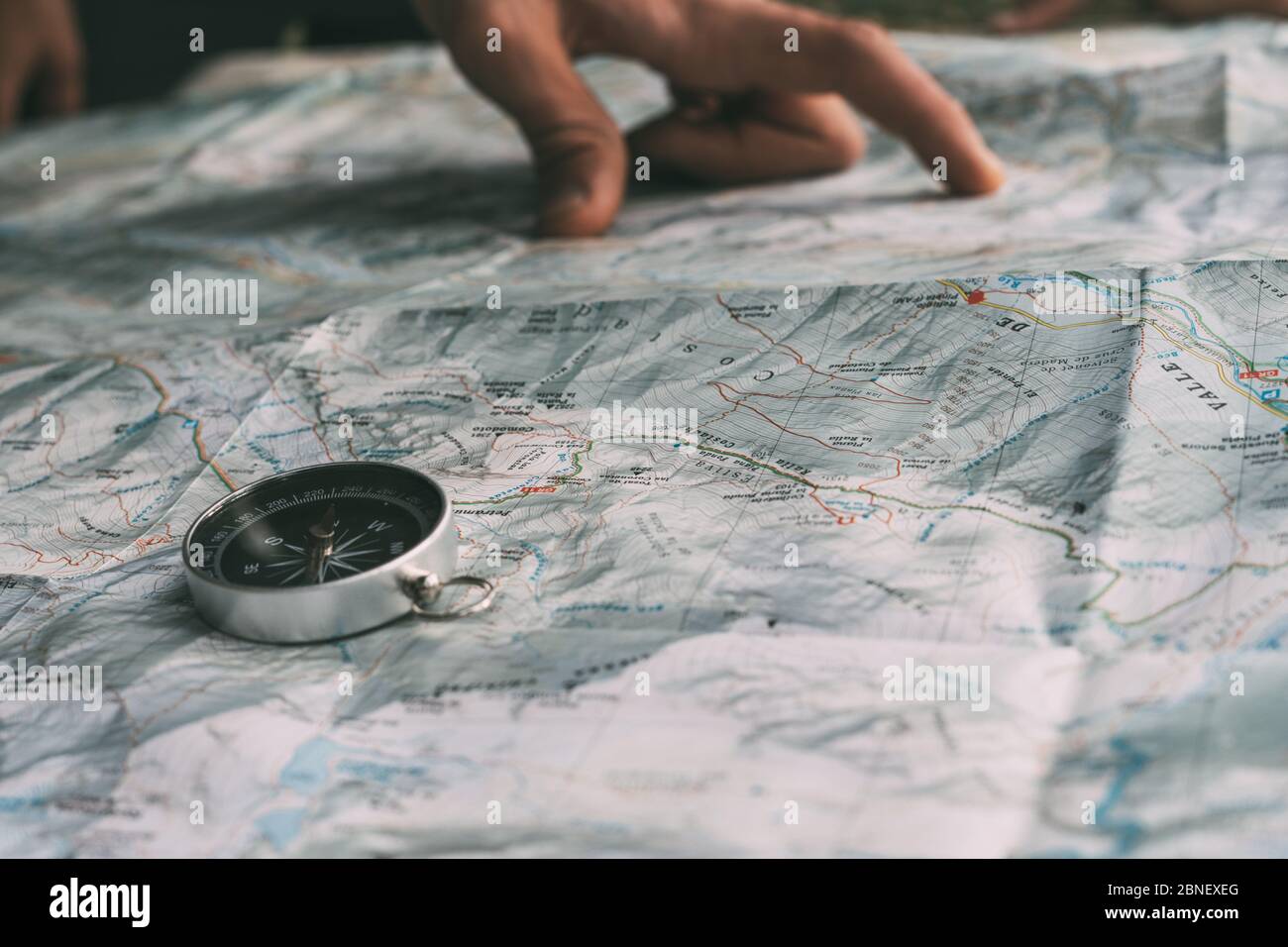Planning the route on a map and a compass Stock Photo