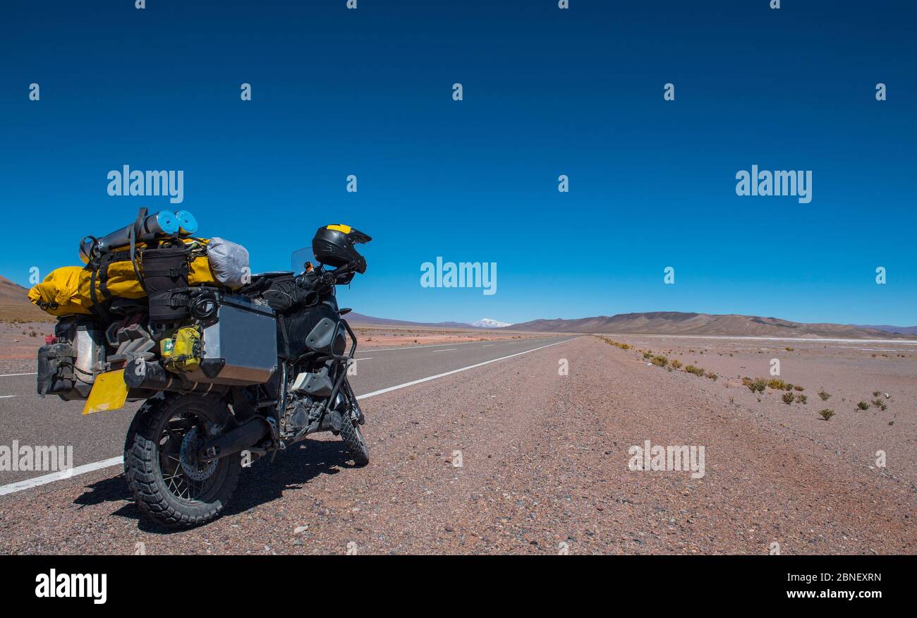 touring motorbike on side of a highway in the Atacama desert / Chile Stock Photo