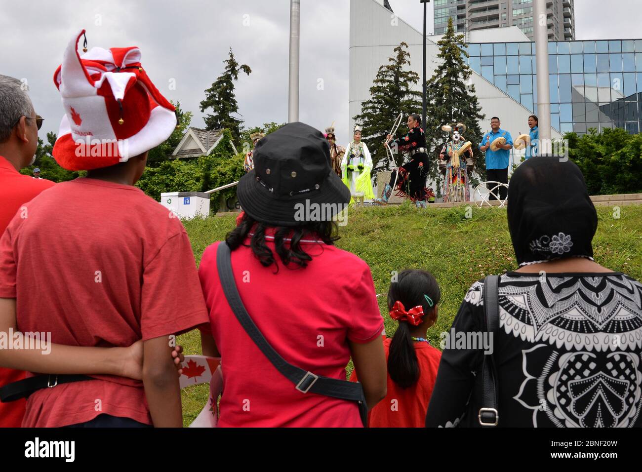 Toronto, Ontario / Canada - July 01, 2017: People gather to watch the Indigenous native People in traditional Native Canadian clothing performing the Stock Photo