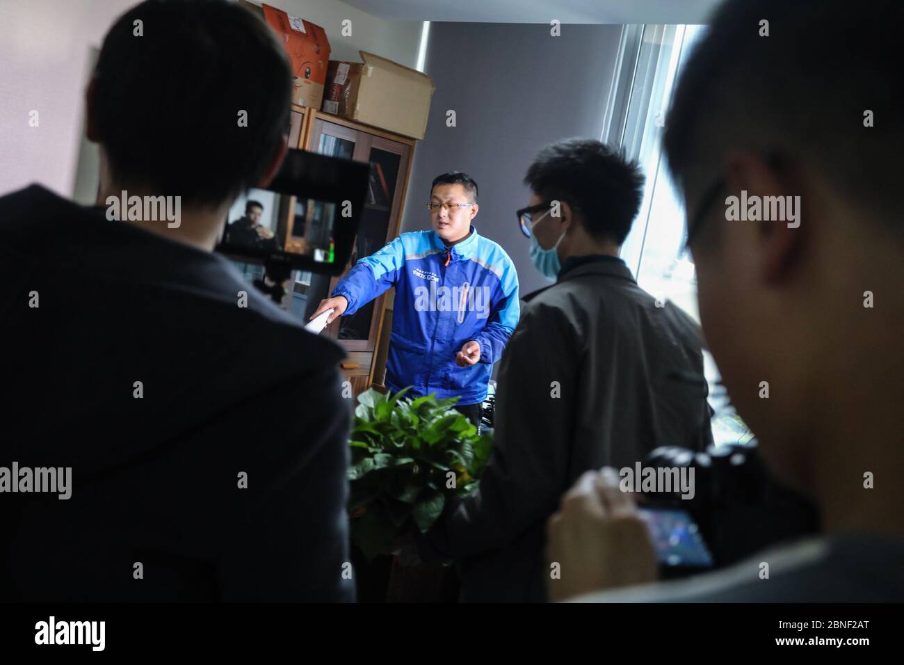 Designer Chen Jian draws to help crews to shoot better videos in Hangzhou city, east China's Zhejiang province, 15 April 2020. Deliverymen of Eleme, a Stock Photo