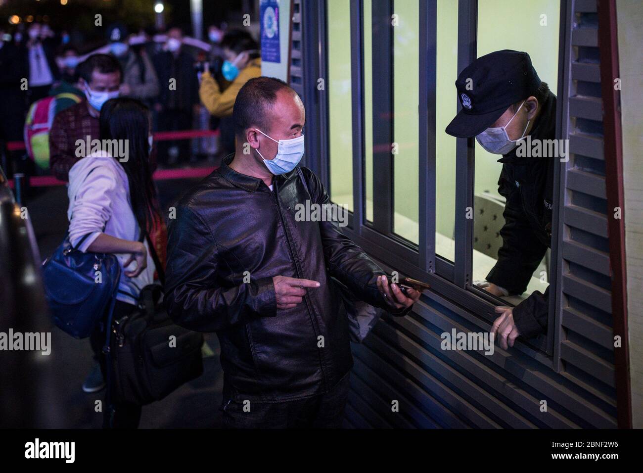 Passengers wait at the train station to leave the city as the lockdown ends, Wuhan city, central China's Hubei province, at midnight of 8 April 2020. Stock Photo