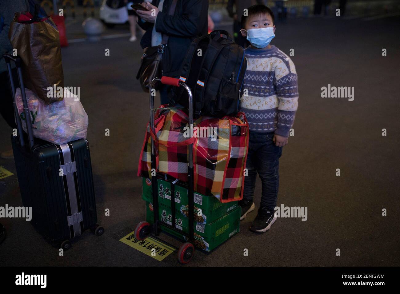 Passengers wait at the train station to leave the city as the lockdown ends, Wuhan city, central China's Hubei province, at midnight of 8 April 2020. Stock Photo