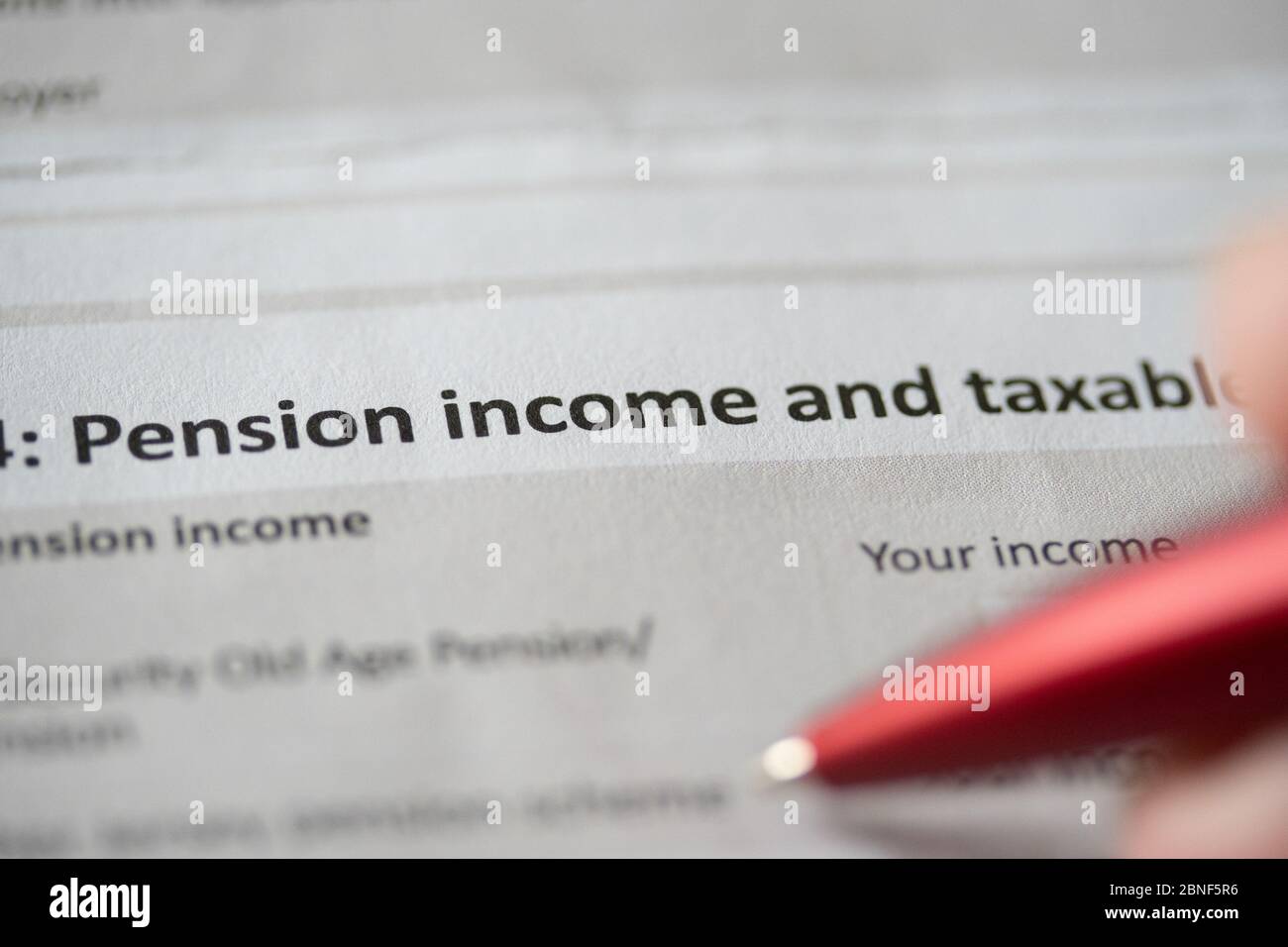 A person filling out pension on a personal tax return