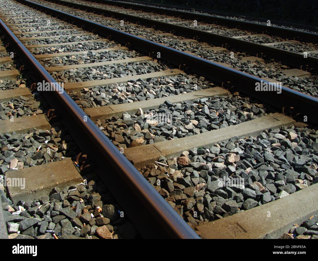 Train railway tracks filled with small rocks and stones Stock Photo - Alamy