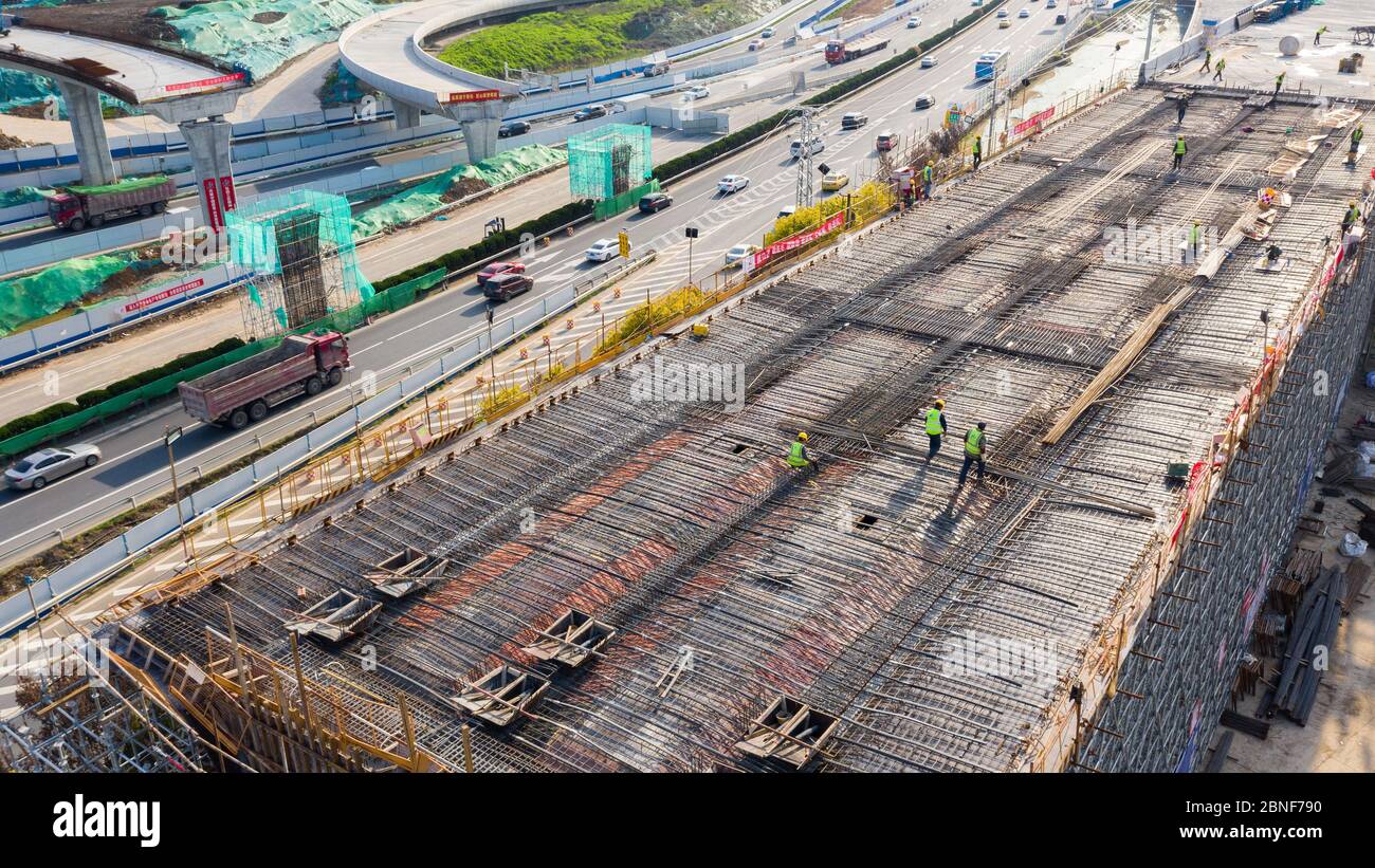 Fly Over Construction Ramp An aerial view of workers busy at the construction site to build the to ...
