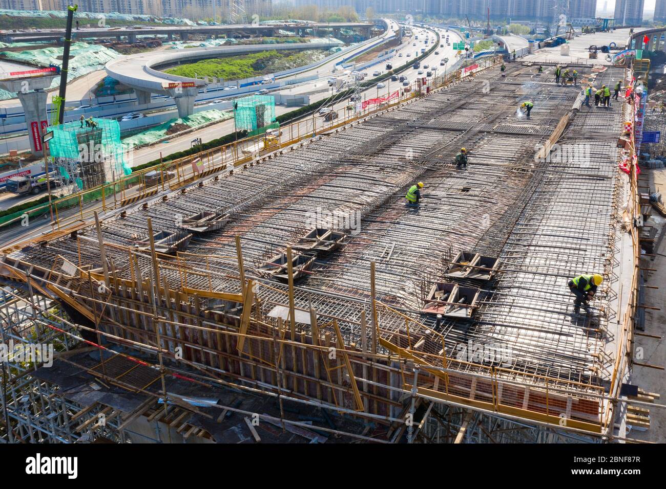 Fly Over Construction Ramp An aerial view of workers busy at the construction site to build the to ...