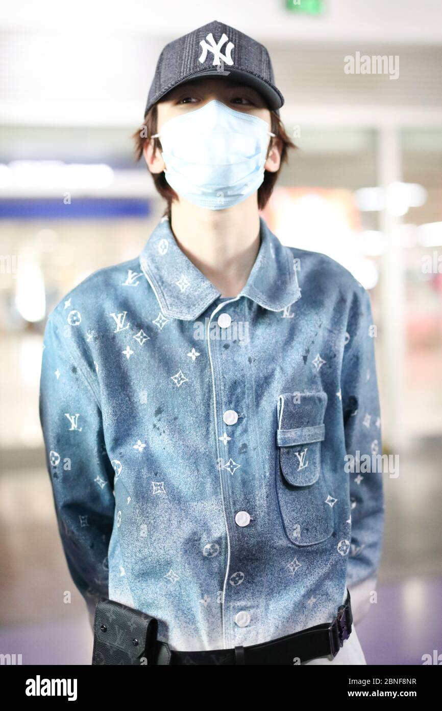 Chinese singer Ling Chao arrives at a Beijing airport before departure ...