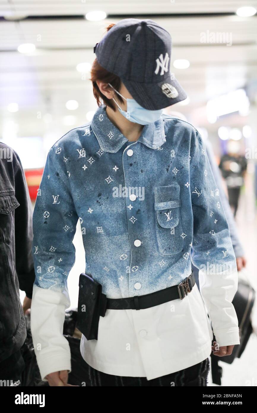 Chinese singer Ling Chao arrives at a Beijing airport before departure ...