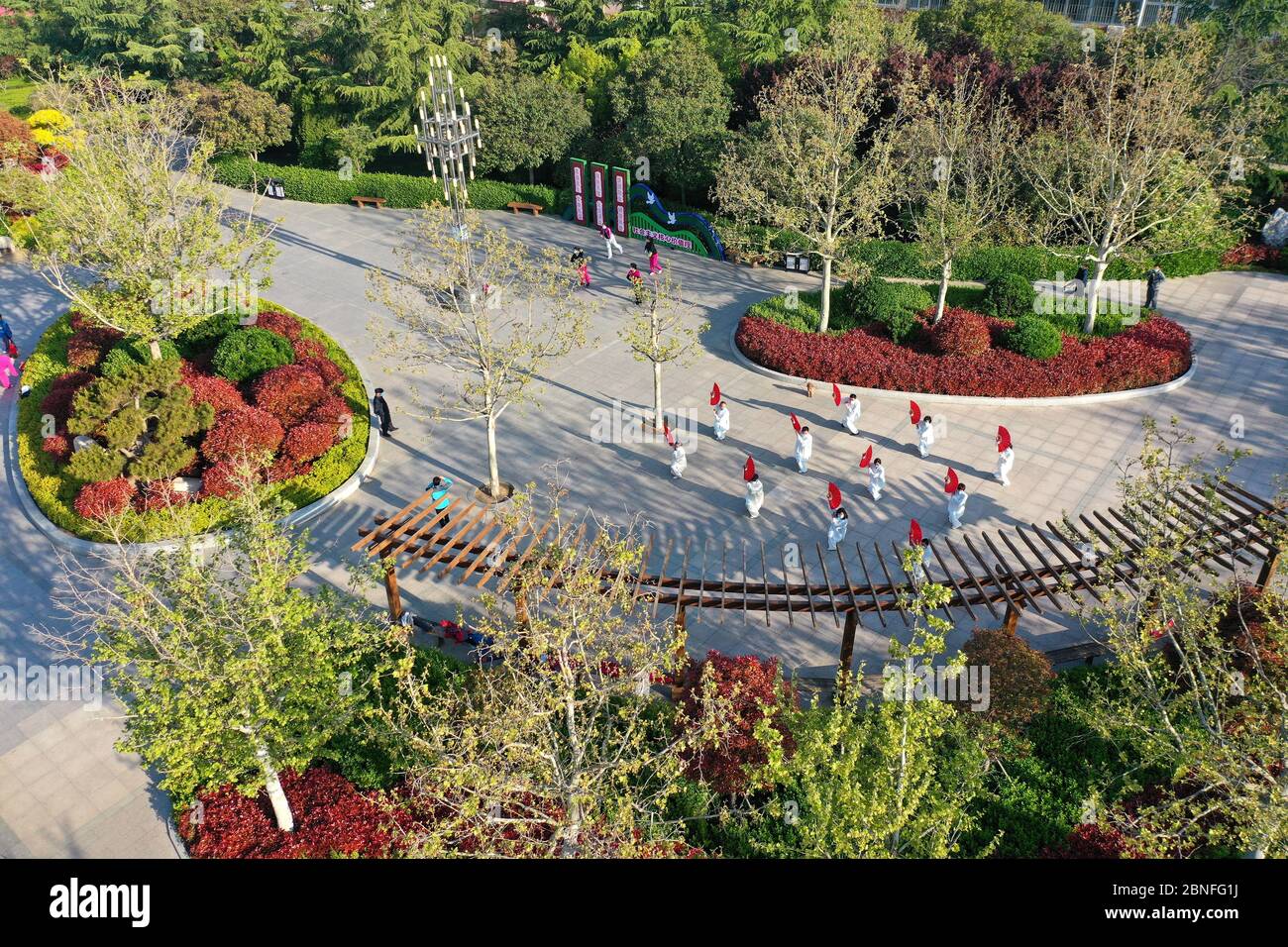 an-aerial-view-of-people-walking-in-a-mini-park-in-qingdao-city-east-chinas-shandong-province-22-april-2020-mini-parks-were-built-in-qingdao-cit-2BNFG1J.jpg