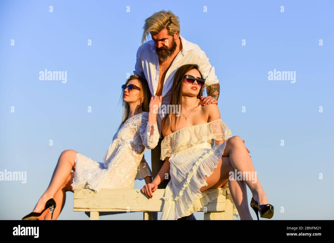 Trio lovers. Free relationship. Threesome concept. In love with both.  Rooftop party. Stylish hipster and women white clothes. Women and man  cuddling. Summer holidays. Relations friendship romance Stock Photo - Alamy