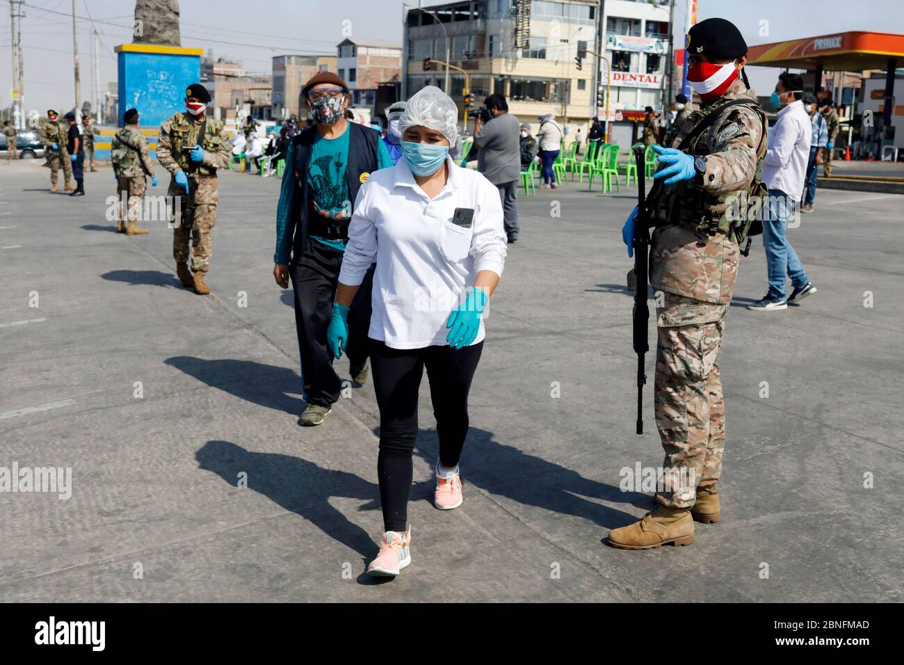 Lima, Peru. 14th May, 2020. A Peruvian soldier guard as market vendors wait in line for blood rapid diagnostic tests for the new coronavirus disease, COVID-19 at a market in Villa El Salvador Credit: Mariana Bazo/ZUMA Wire/Alamy Live News Stock Photo