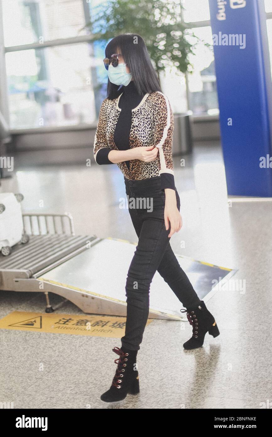 Chinese television and film actress Tan Zhuo arrives at a Chengdu airport before departure in Chengdu city, southwest China's Sichuan province, 14 Apr Stock Photo