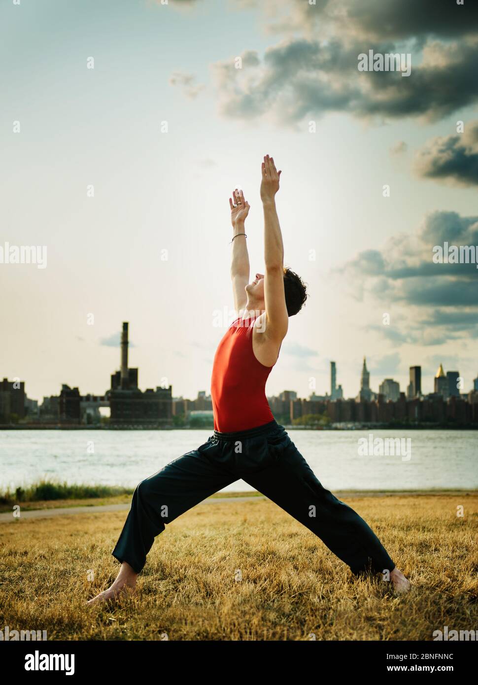 young man doing yoga in the park Stock Photo