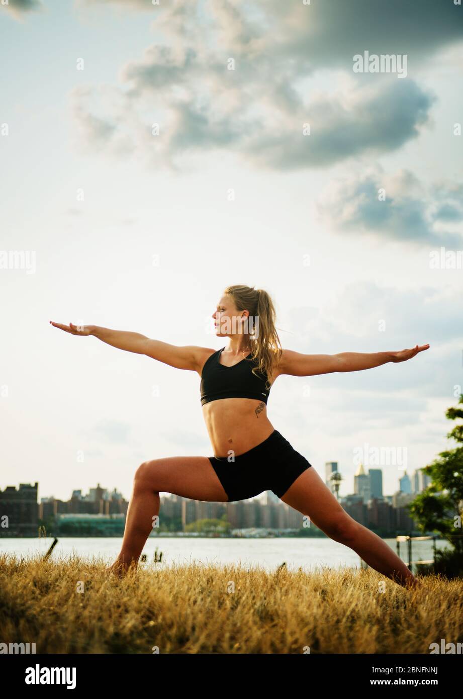 Woman doing Yoga in the park, Brooklyn, New York Stock Photo