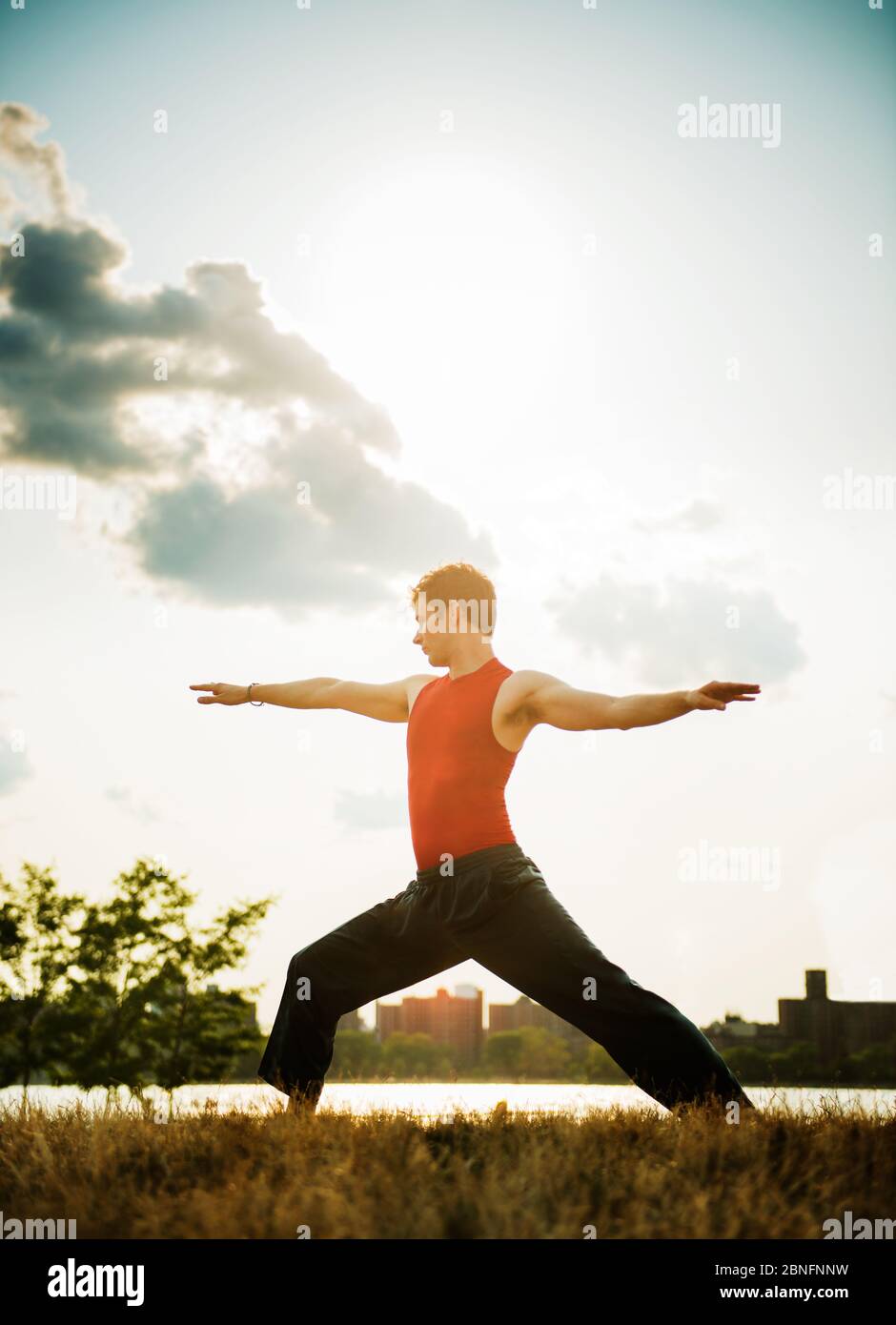 young man doing yoga in the park Stock Photo