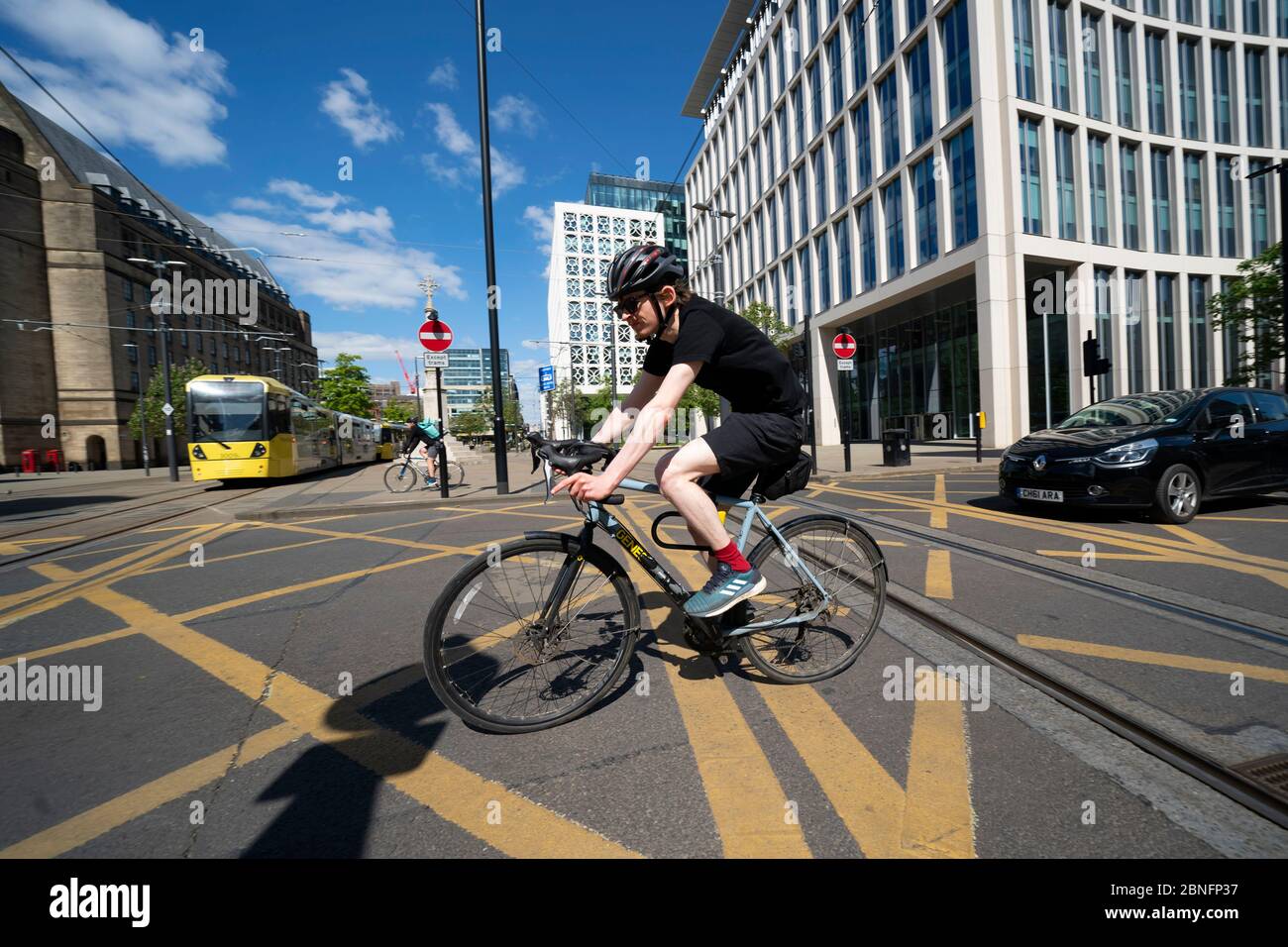 Manchester, Britain. 14th May, 2020. A man rides a bicycle in Manchester, Britain, on May 14, 2020. British Transport Secretary Grant Shapps on May 9 announced a 2-billion-pound (2.5-billion-U.S.-dolar) package to encourage cycling and walking amid the COVID-19 pandemic as another 346 patients have died in the country. The move came as the government strives to double cycling and increase walking by 2025 with a national cycling plan being expected to be published in June. Credit: Jon Super/Xinhua/Alamy Live News Stock Photo