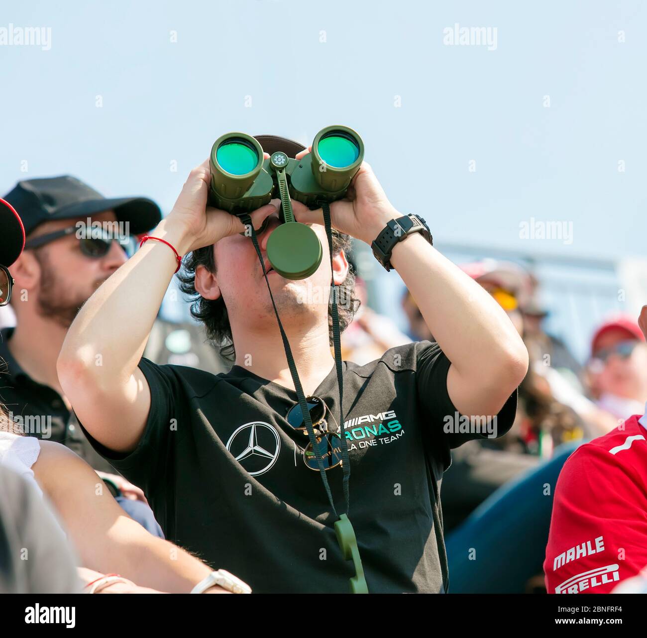 Motor sport spectator with binoculars Stock Photo