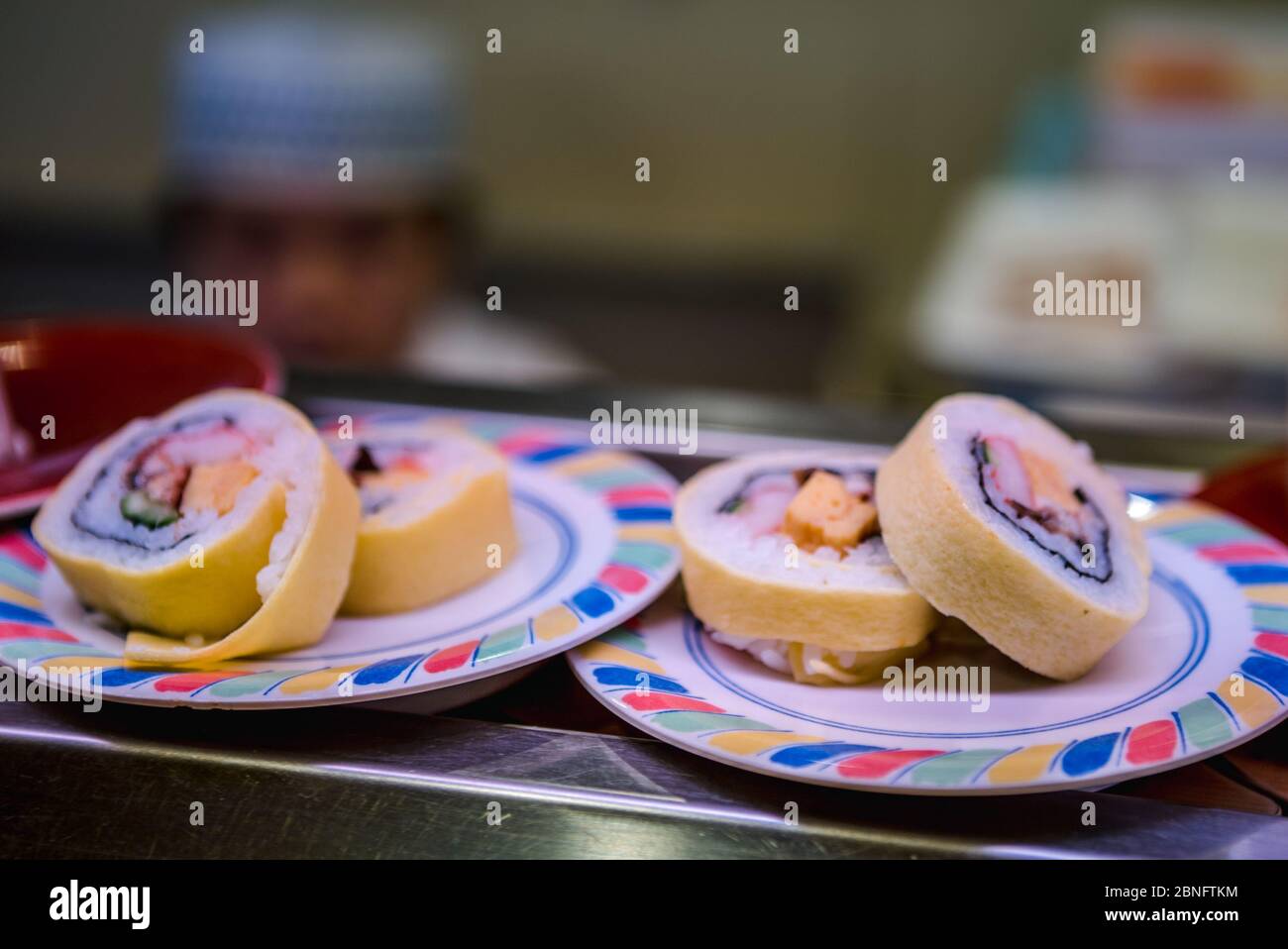 Sushi on conveyor belt in a Japan restaurant. Traditional Kaitenzushi