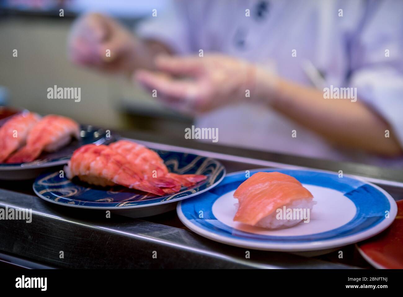 Sushi on conveyor belt in a Japan restaurant. Traditional Kaitenzushi