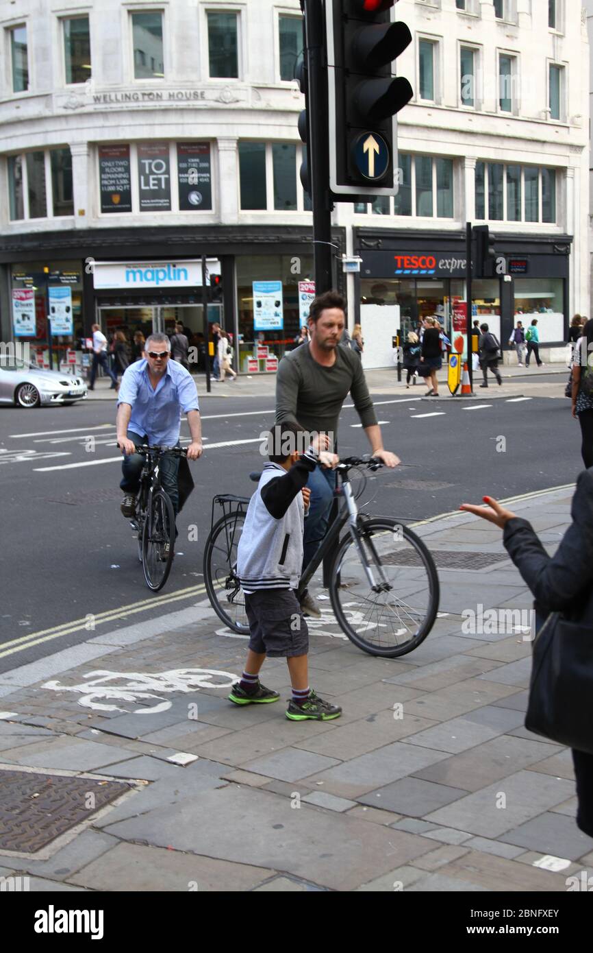 Cyclists and pedestrians. Road users. Cyclists and Motorists. Rules of the road. London traffic. London cycle lanes. Near misses. Close shave. Cycle lanes. Stay alert. Save lives. Danger. Every day living. complex lives. Bag of nerves. Cycling. Public spaces. Other road users. Dangerous riding. Driving. Walking. Urban living. Busy lives. Life in the city. City living. Life in your hands. Risk. Keeping active. Stock Photo