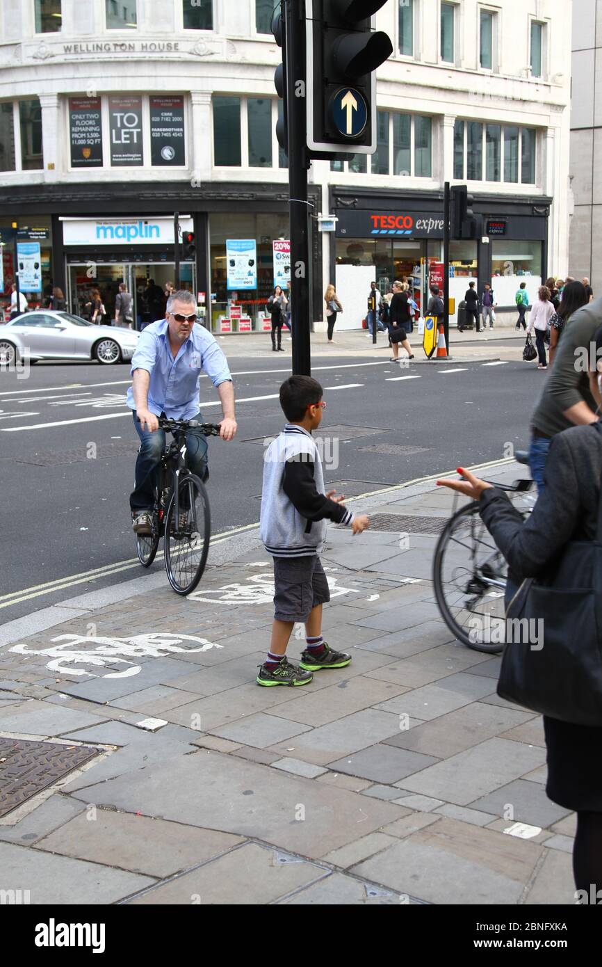 Cyclists and pedestrians. Road users. Cyclists and Motorists. Rules of the road. London traffic. London cycle lanes. Near misses. Close shave. Cycle lanes. Stay alert. Save lives. Danger. Every day living. complex lives. Bag of nerves. Cycling. Public spaces. Other road users. Dangerous riding. Driving. Walking. Urban living. Busy lives. Life in the city. City living. Life in your hands. Risk. Keeping active. Stock Photo