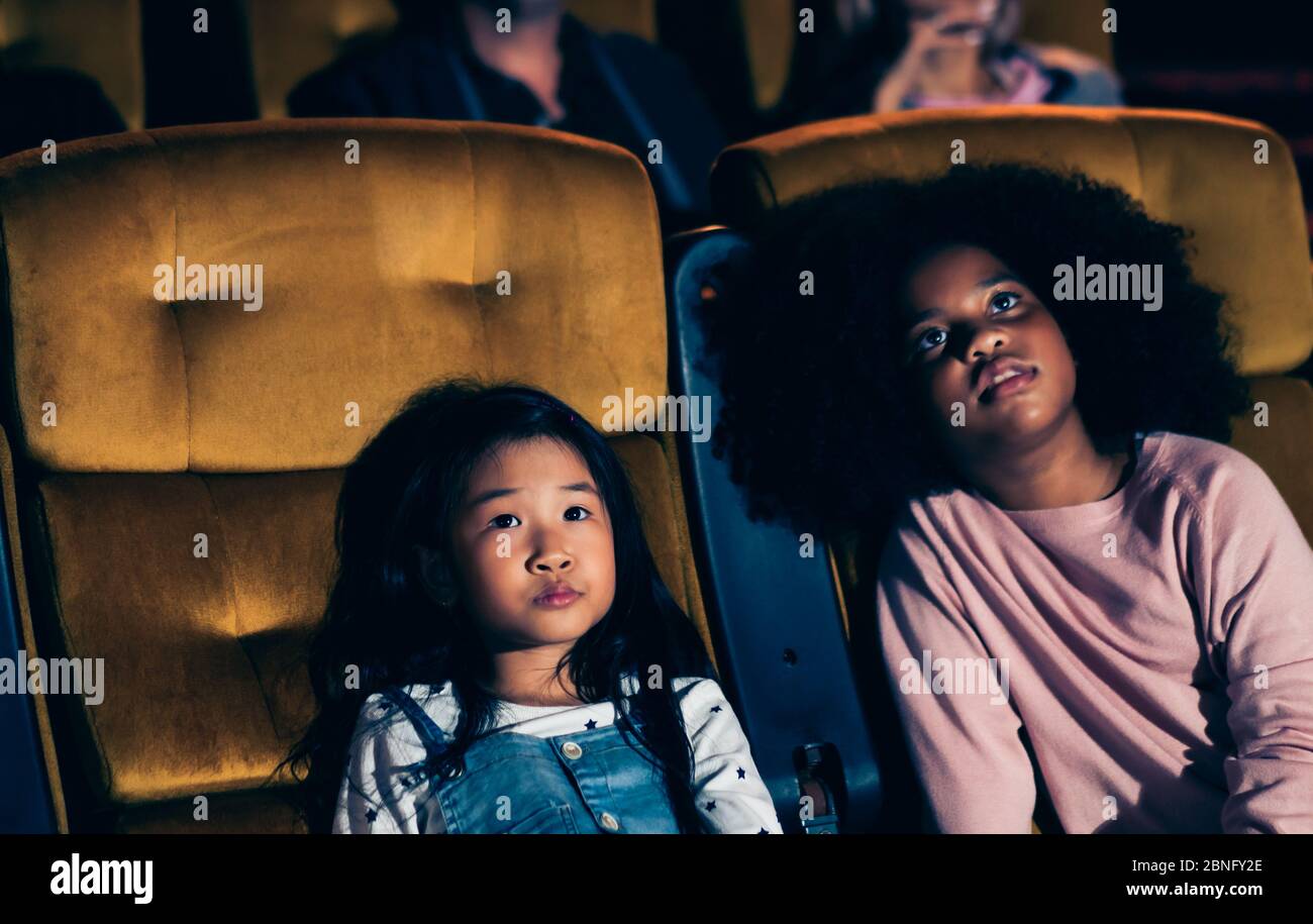 Three Children Having Fun And Enjoy Watching Movie In Cinema Stock Photo Alamy