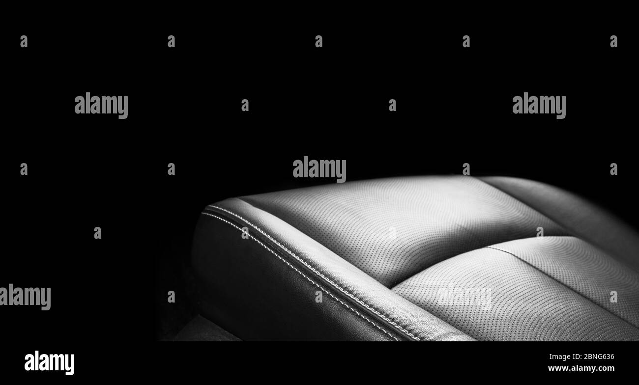 Luxury car black leather interior. Part of leather car seat details with stitching. Interior of Luxury car black leather interior. Part of leather car seat details with stitching. Interior of