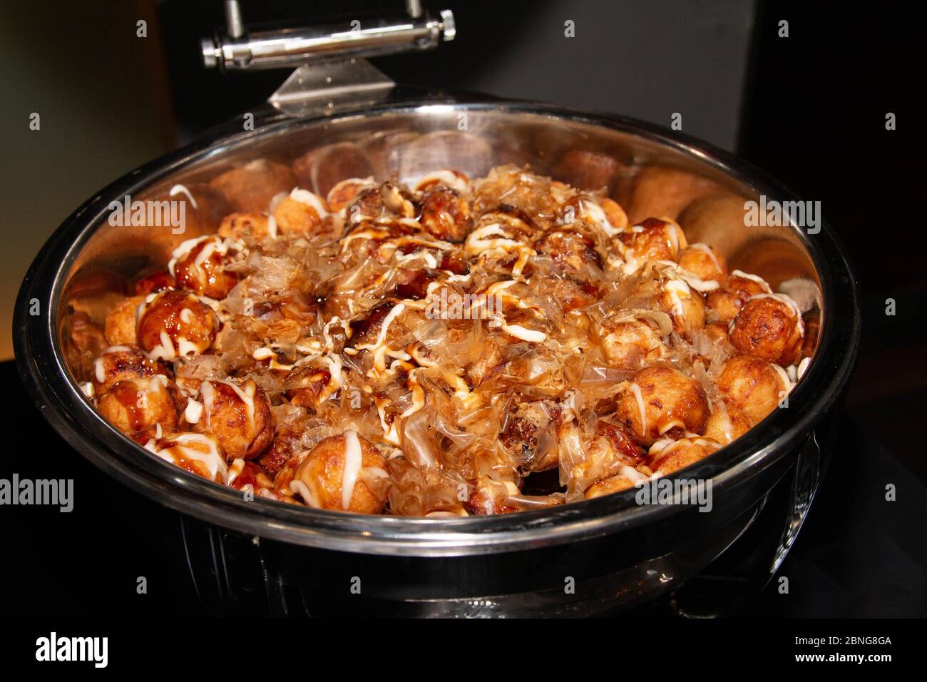 Large portion of Japanese street food, Takoyaki, with dried bonito